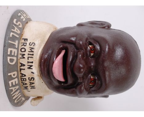 MONEY BOX; A 20th century antique style hand painted ' Smilin Sam From Alabam ' negro novelty money box with automaton action
