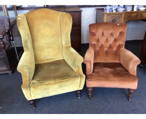 A 19 century upholstered wing back fireside chair with turned legs together with a button backed easy chair. IMPORTANT: Onlin
