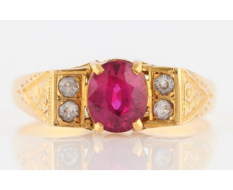 A ruby and colourless paste ring, set with an oval cut ruby, possibly synthetic, measuring approx. 6x5mm, flanked to either s
