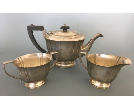 A silver three piece bachelors tea set including tea pot with ebony handle and finial with milk jug and sugar bowl, hallmarke