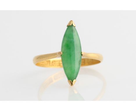 A green jadeite jade ring, set with a marquise jadeite cabochon, yellow metal stamped with Chinese character marks, ring size