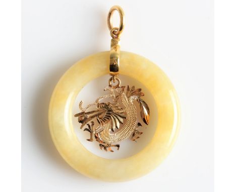 A jade circle design pendant, with a central open metalwork dragon dropper, unmarked yellow metal, diameter approx. 3.5cm. IM