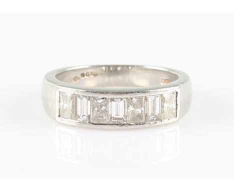 A platinum diamond half eternity ring, channel set with seven alternating emerald and princess cut diamonds, total diamond we