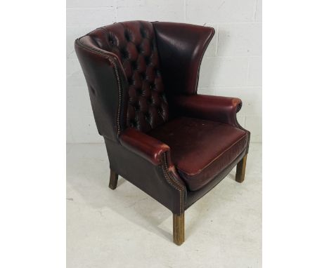 An Chesterfield style Ox blood armchair with button back detailing