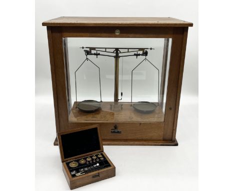 A cased set of vintage Philip Harris & Co scales with sliding glass door along with a cased set of weights 