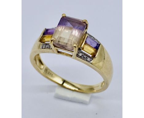 A 9ct gold dress ring set with citrines and amethysts