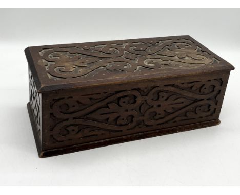 A vintage wooden box with carved detail 