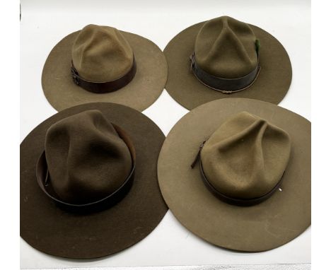 A collection of four vintage Boy Scout felt hats including a Baden Powell with hat badge, Scoutmaster etc. 