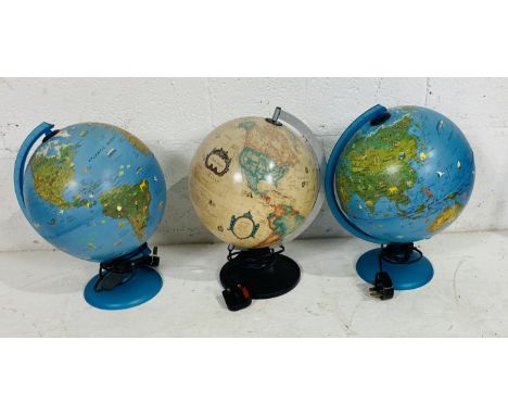A collection of three light-up globes