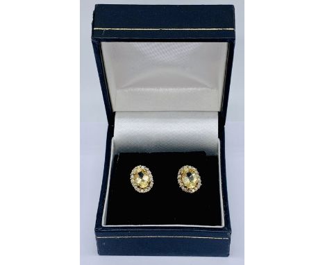 A pair of citrine and diamond cluster earrings set in 9ct gold