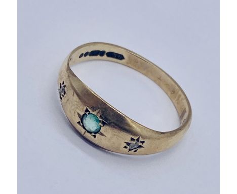 An emerald and diamond three stone ring set in 9ct gold