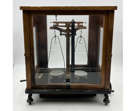 A cased set of scales by L Oertling the case in need of some attention