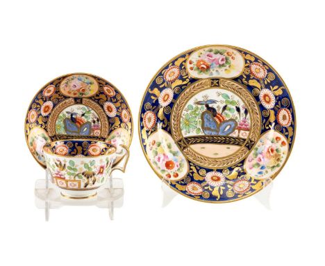 SWANSEA PORCELAIN TRIO circa 1815-17, richly decorated with set pattern '219' of panels of European flowers reserved on mazar