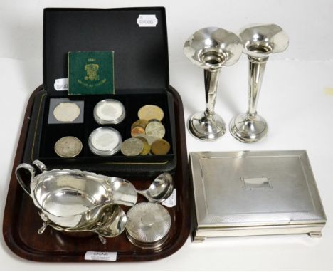 A group of silver including a cigarette box, two sauce boats, a sauce ladle, two bud vases, pill box, and a small group of co