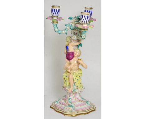 A Meissen porcelain three light candelabrum with figural support on a rocaille base (restored) 