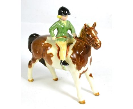 Beswick Girl on Pony, model No. 1499, skewbald glossChip to underside of right hoof, minor crazing, otherwise good condition.