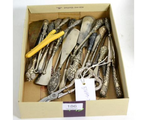 A large collection of silver handled button hooks and shoe horns; together with two pairs of silver handled glove stretchers 
