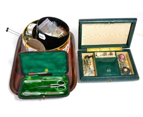 A silver bangle with engraved decoration; a silver handled manicure set; other silver jewellery and an assortments of costume