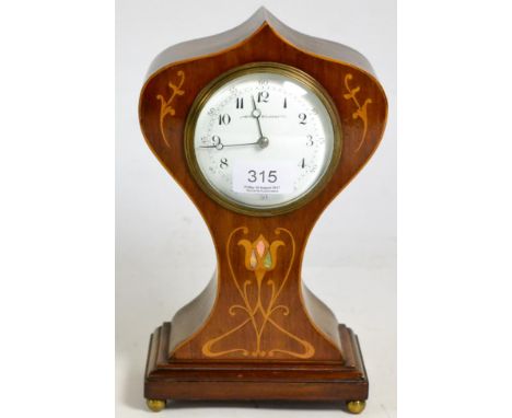 An Edwardian Art Nouveau inlaid mantel timepiece 
