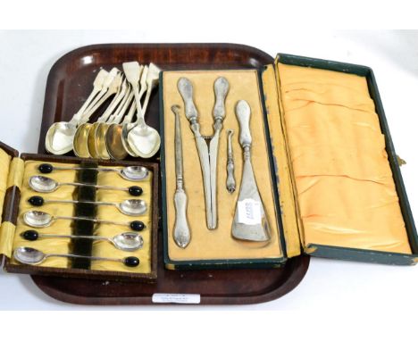 A cased set of button hooks etc, with silver handles; cased set of silver bean top spoons and a quantity of silver fiddle pat