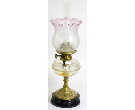 A Victorian oil lamp with clear glass reservoir and etched glass shade