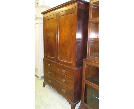 LINEN PRESS, Regency mahogany with two panelled doors enclosing a hanging rail above two short and two long drawers on bracke