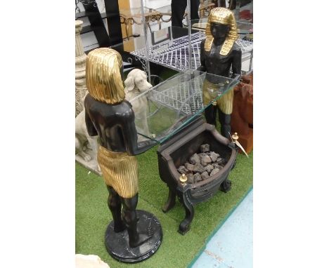 MAISON JANSEN CONSOLE TABLE, with a rectangular glass top and twin bronze and gilded Egyptian figural supports, 118cm H x 132