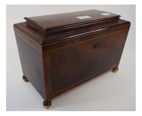A mahogany tea caddy, of sarcophagus form, crossbanded and inlaid, with fitted interior, 31 cm wide
