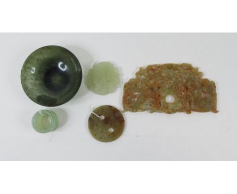 A jade bowl, 9 cm diameter, a green hardstone archers ring, and three plaques (5)