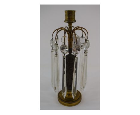 A bronze figural candlestick, with prismatic drops, 24.5 cm high
