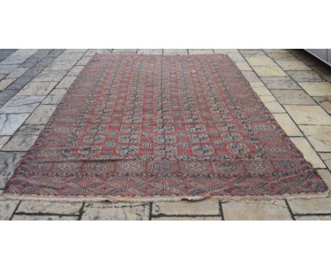 A Tekke Turkoman carpet, 336 x 233 cm  Condition report Report by GHGenerally colour faded and quite worn with some light sta