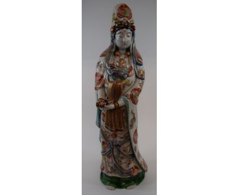 A Chinese figure, of a sage holding a scroll, 47 cm high