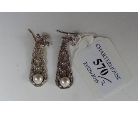 A pair of 9ct gold and silver bow top earrings