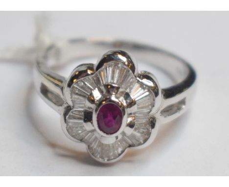 An 18ct white gold, baguette cut diamond and ruby ring