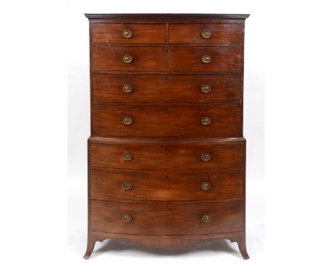 An early 19th century bow front mahogany tallboy chest on chest, having two short and three graduated long drawers, above thr