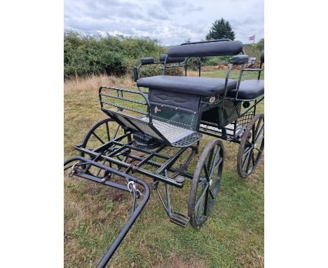 WAGONETTE by Hartland, in racing green bodywork and black upholstered seats, seating at rear for two, with wide low back step