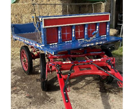 LONDON TROLLEY to suit a single 12-14hh pony, with a red undercarriage, blue body, and metal railed seat back. On pneumatic t
