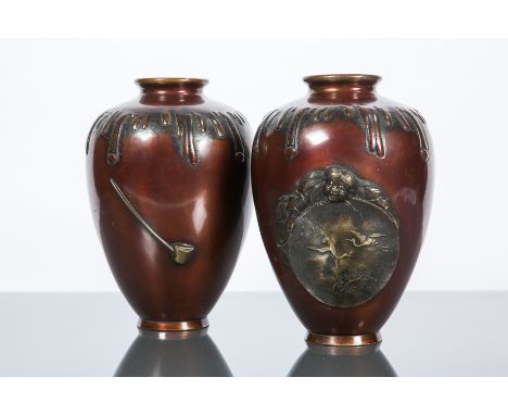 PAIR OF EARLY 20TH CENTURY JAPANESE PATINATED BRONZE VASES
with overlay decoration of a figure holding a circular painting of