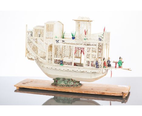 EARLY 20TH CENTURY CHINESE IVORY MODEL OF A BOAT
with painted figures and details, 39cm wide, on a wooden stand 