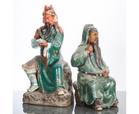 TWO 20TH CENTURY CHINESE CERAMIC FIGURES OF MALES 
each modelled seated and with long beards, 42cm and 32cm high (2)
