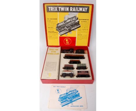 A Trix Twin Railway post war BR goods train containing freelance 0-4-0 engine and  tender together with 6 wagons and instruct