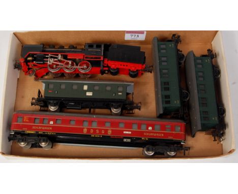 A Fleischmann H0 2-6-0 engine and tender DB black (G) 3 green four wheel coaches and a DSG red bogie 'Schlafwagen' (G)