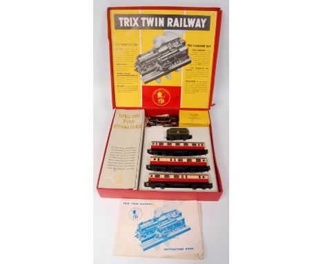 A Trix Twin Railway post war BR passenger set containing lined green freelance 0-4-0 engine and tender, 3 red/cream coaches a