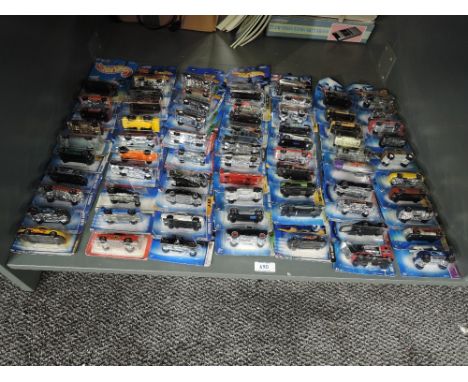 A shelf of Mattel Hot Wheels die-casts, 2003 period onwards, 70 in total, all on bubble display cards, all appear unopened