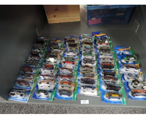 A shelf of Mattel Hot Wheels die-casts, 2006 period, 55 in total, all on bubble display cards, all appear unopened