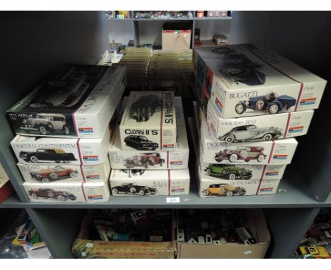 Twelve Monogram 1:24 scale Vintage Car plastic Model Kits, all opened, some part made, not checked for compleness