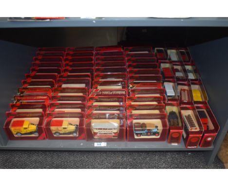 A shelf of Matchbox Models of Yesteryear die-casts, Vintage Trucks and Buses, 56 in total, all in window display boxes