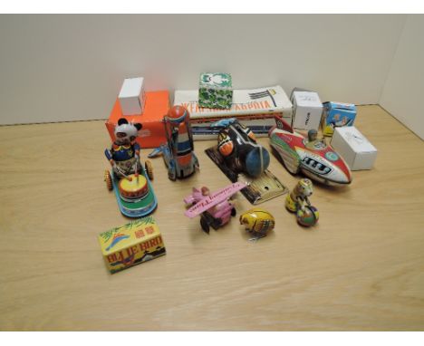 A collection of mixed vintage Tin Plate Toys including Rocket Racer, Training Plane, Woodpecker, Panda playing drums, mainly 