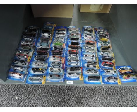 A shelf of Mattel Hot Wheels die-casts, 2005 period, 61 in total, all on bubble display cards, all appear unopened