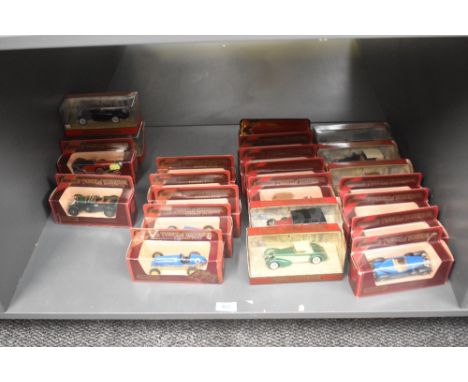 A shelf of Matchbox Models of Yesteryear die-casts, Vintage Cars  23 in total including Grand Prix Series, all in window disp